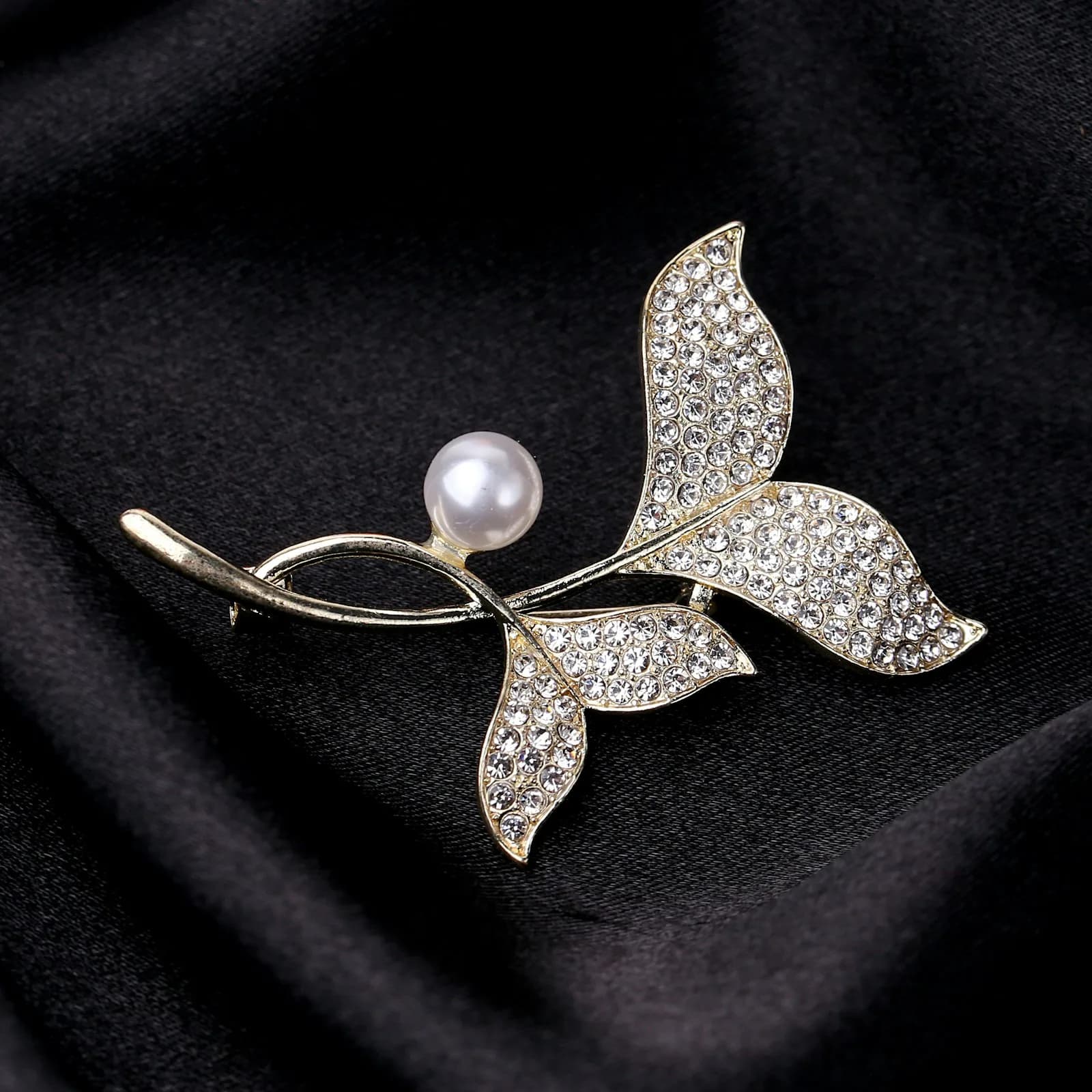 Pearl and crystal butterfly hijab pin on black fabric