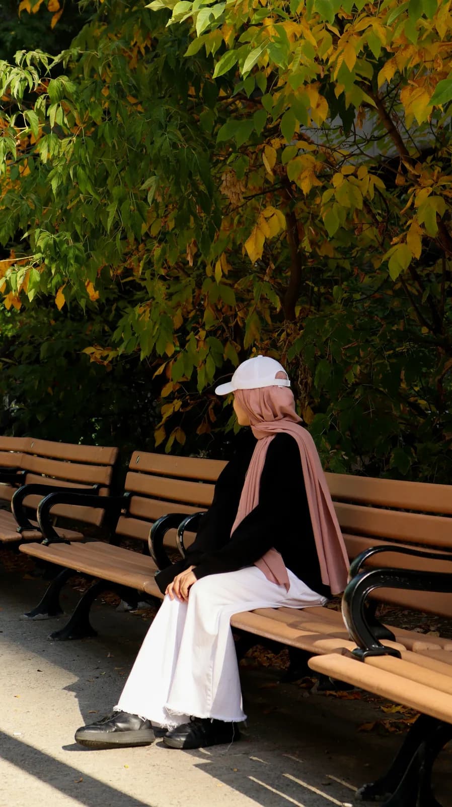 Blush hijab with black top and white wide-leg trousers