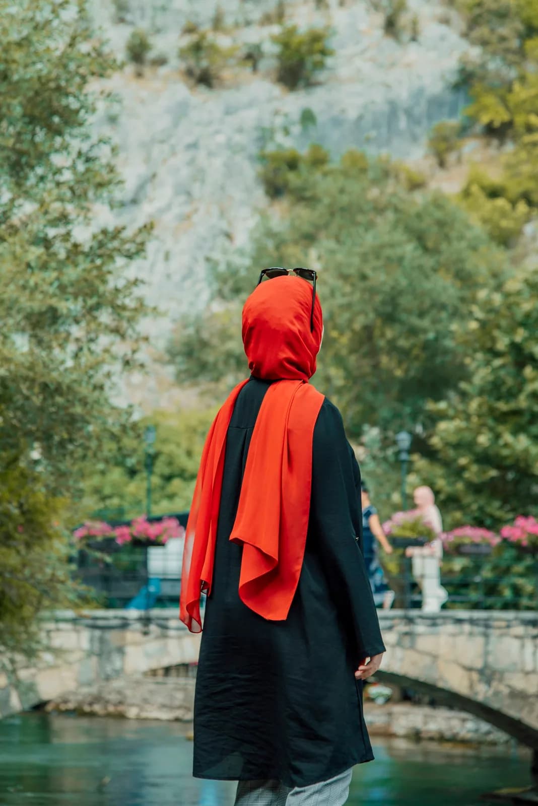 Woman wearing a draped crimson silk hijab